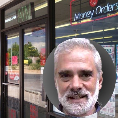 Convenience store entrance with photo inset of an older man with white hair, mustache and beard
